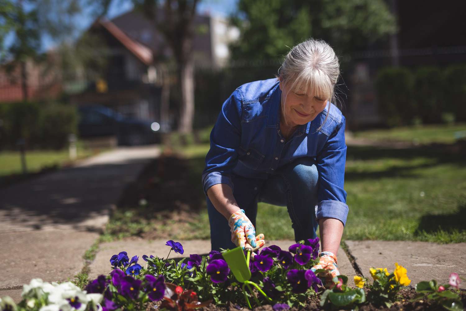 Woman planting flowers in yard
