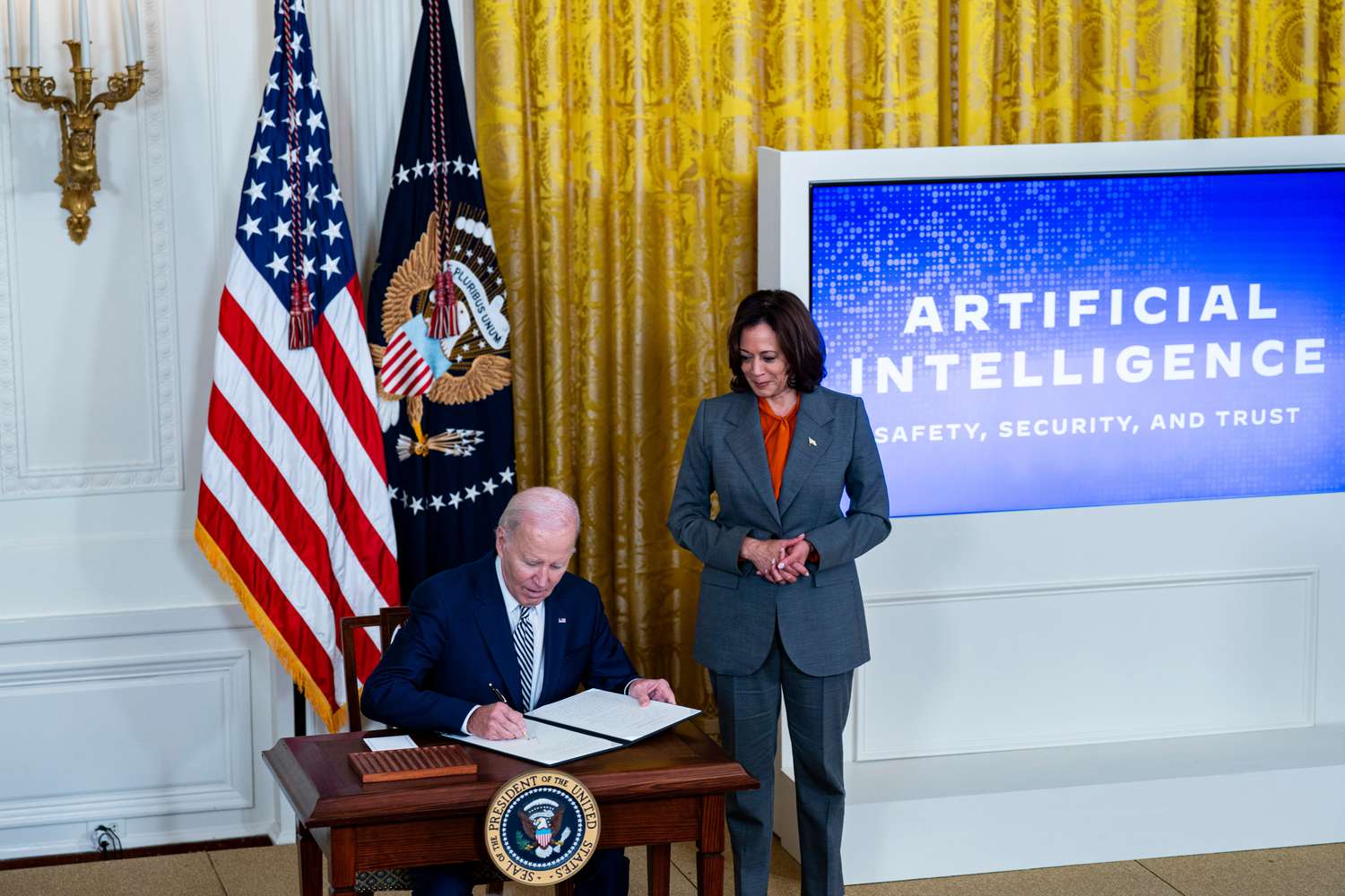 U.S. President Joe Biden signs an executive order with Vice President Kamala Harris during an event at the White House in October.