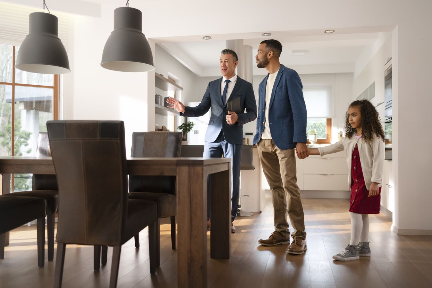 Dad with child viewing a house with a real estate agent once they get their mortgage through LendingTree.