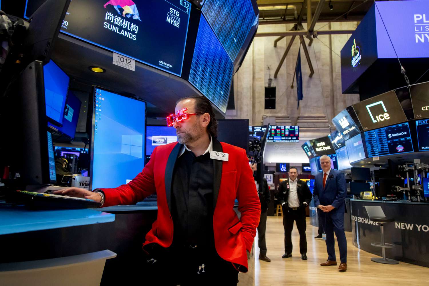 A trader wears 2025 glasses while working on the floor of the New York Stock Exchange (NYSE) in New York, US, on Tuesday, Dec. 31, 2024.