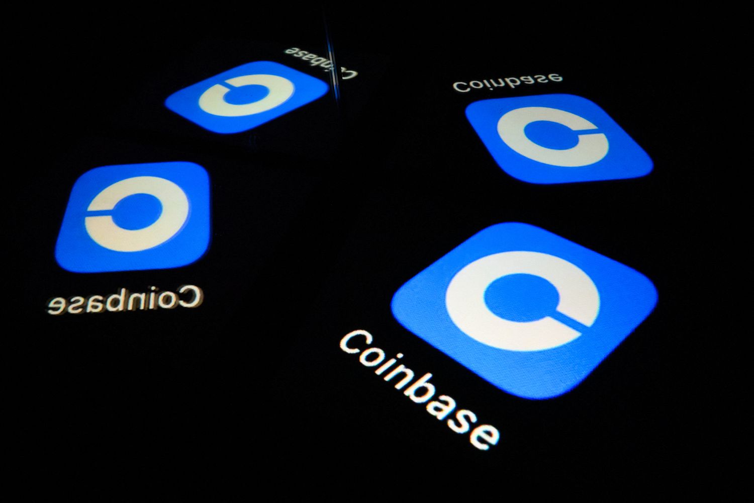 Screens show the logo of Coinbase Global