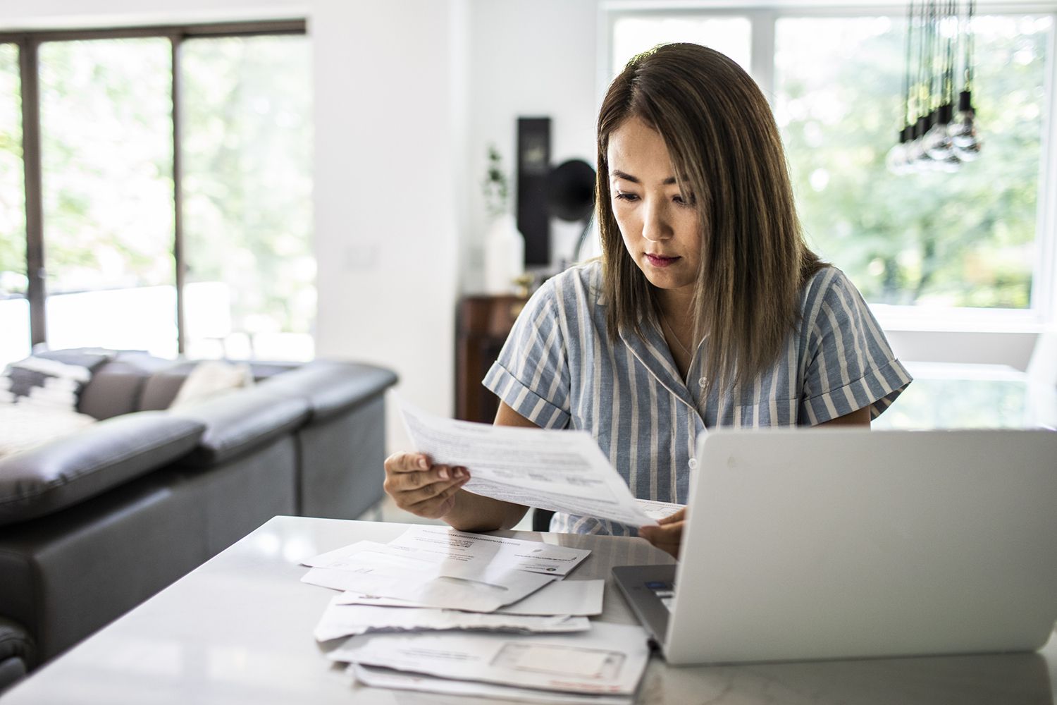 Woman with papers and a laptop
