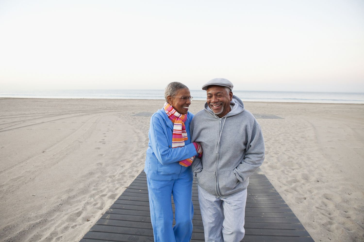 Older adult couple walking on beach
