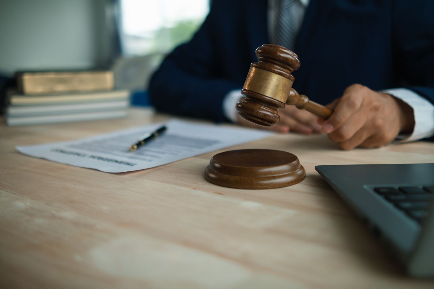 A judge bangs a gavel after issuing a writ of seizure and ordering the sale of a property that was under default.