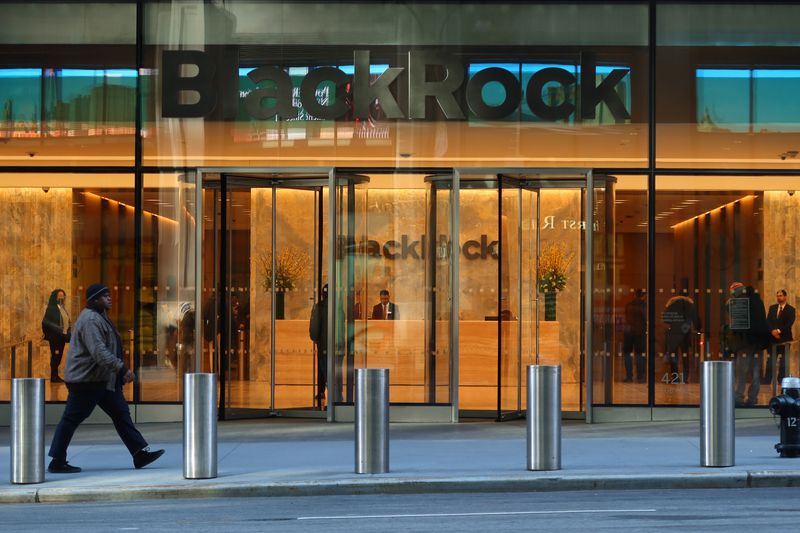 A person walks by the front entrance of the headquarters for the investment management firm BlackRock