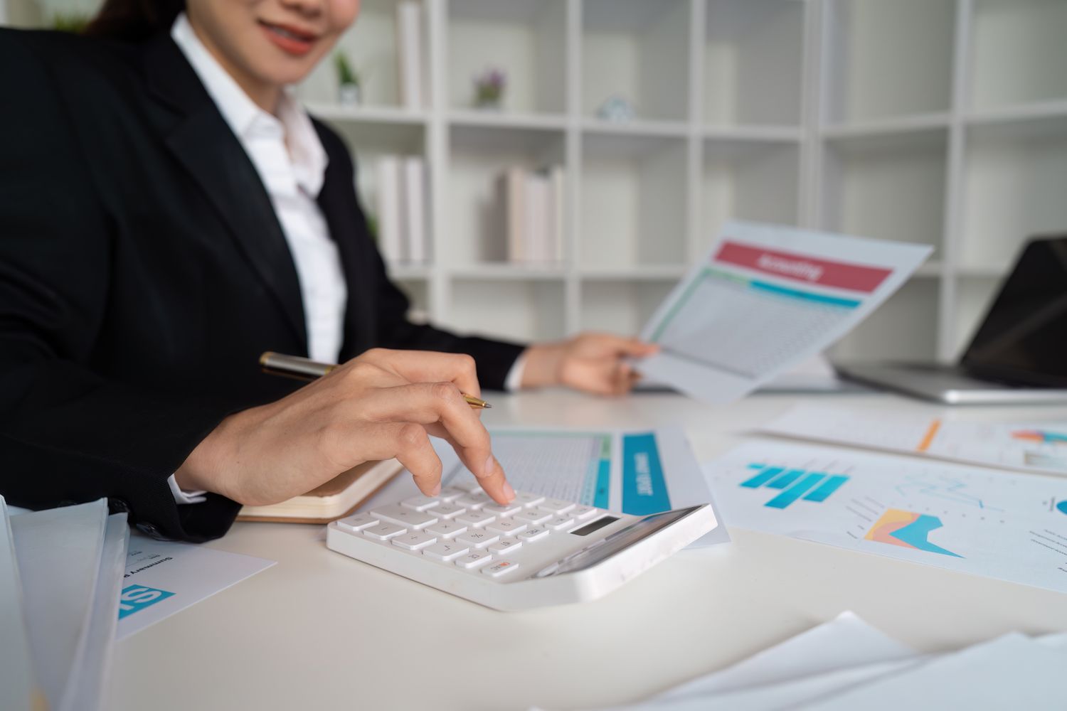 A woman with a calculator and papers