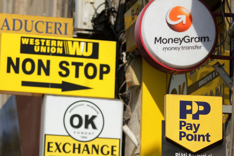 October 10, 2018: Several Western Union, MoneyGram and Pay Point commercials are seen on a street in downtown Bucharest. 