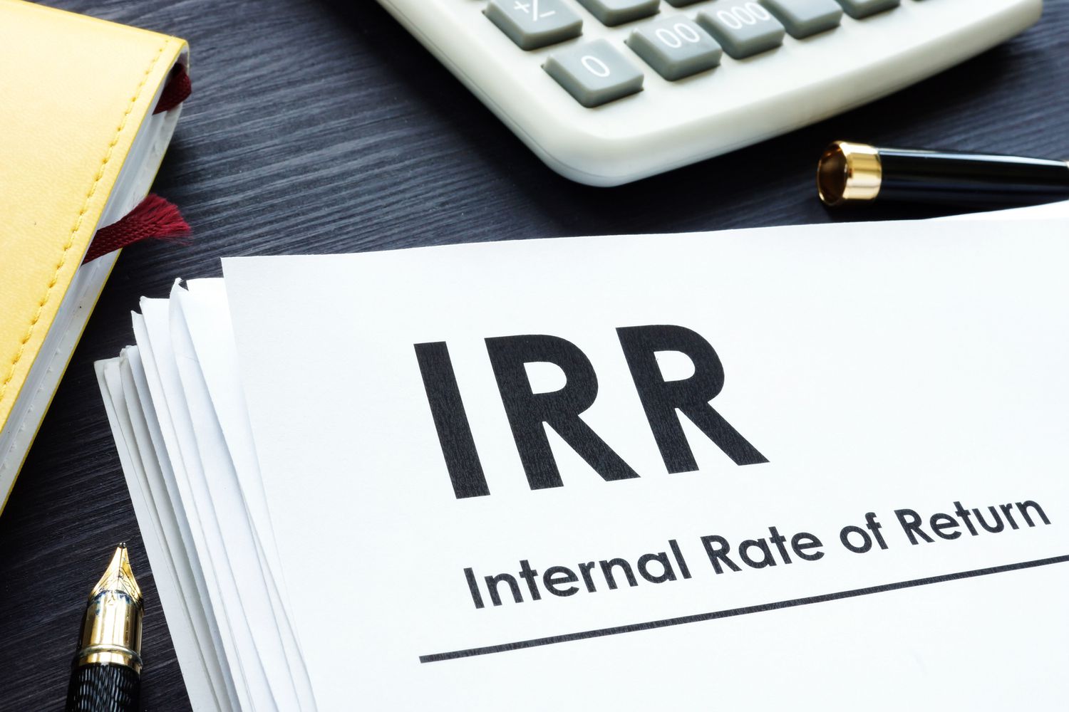 A desk with paper that says Internal Rate of Return