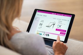 Closeup of woman doing online shopping on digital tablet at home