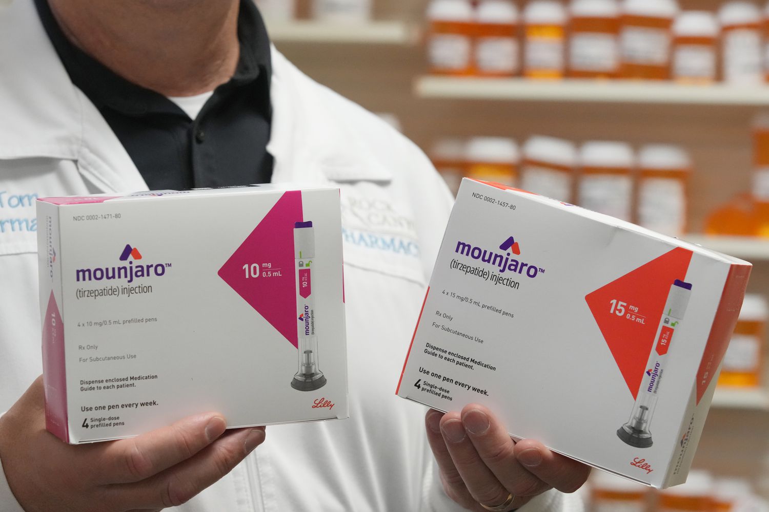 A pharmacist holds boxs of Eli Lilly & Co. Mounjaro brand tirzepatide medication arranged at a pharmacy in Provo, Utah, US, on Monday, Nov. 27, 2023. 