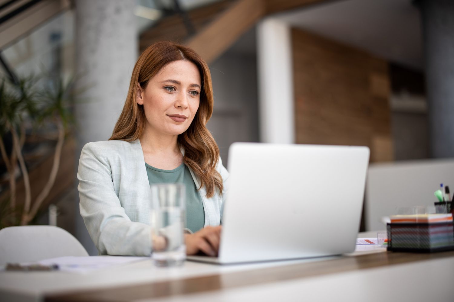 Woman working from a laptop at a desk