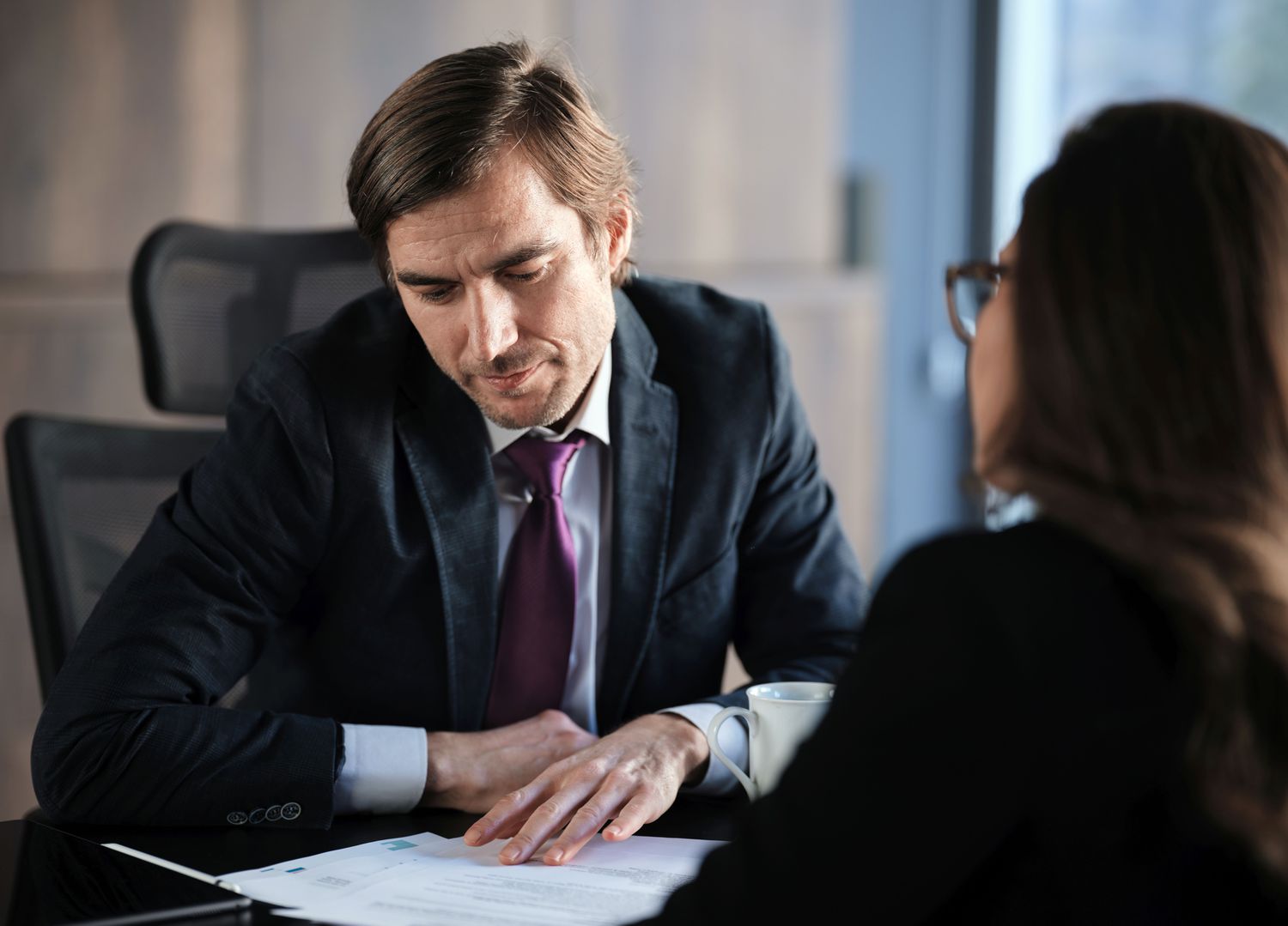 Man looking at paperwork in an office meeting