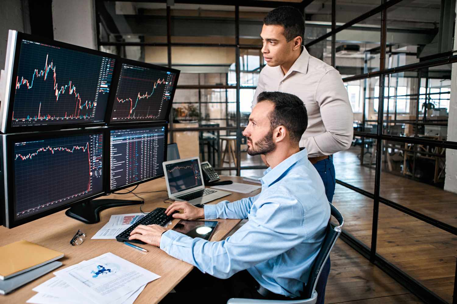 Traders looking at market screens in an office