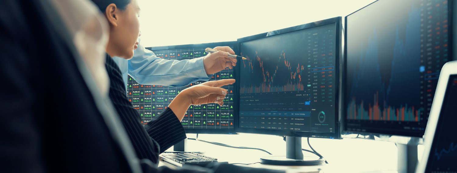 Traders working on computer terminals