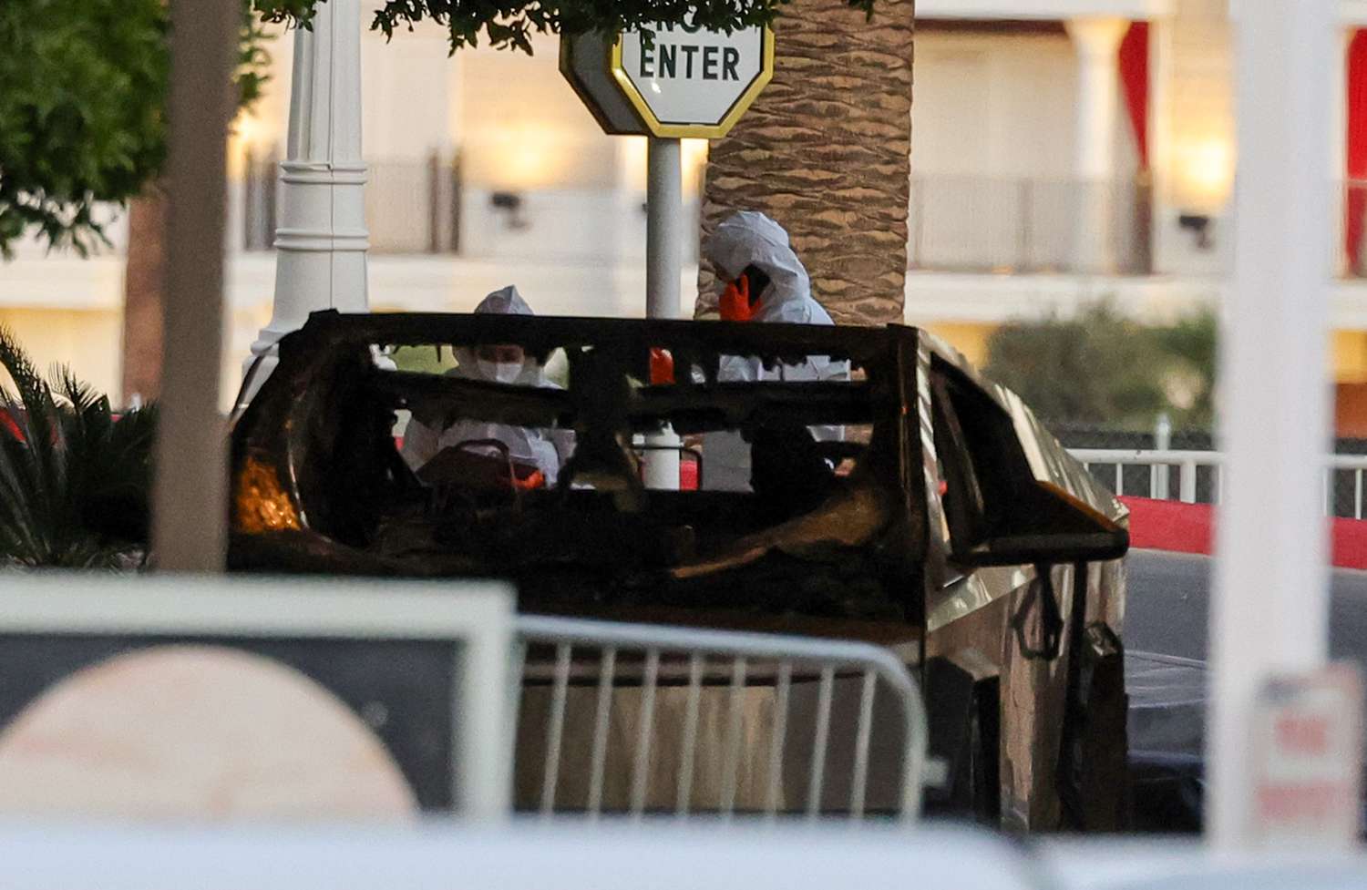 First responders wearing Hazmat gear investigate a Tesla Cybertruck that exploded in front of the entrance to the Trump International Hotel & Tower Las Vegas .