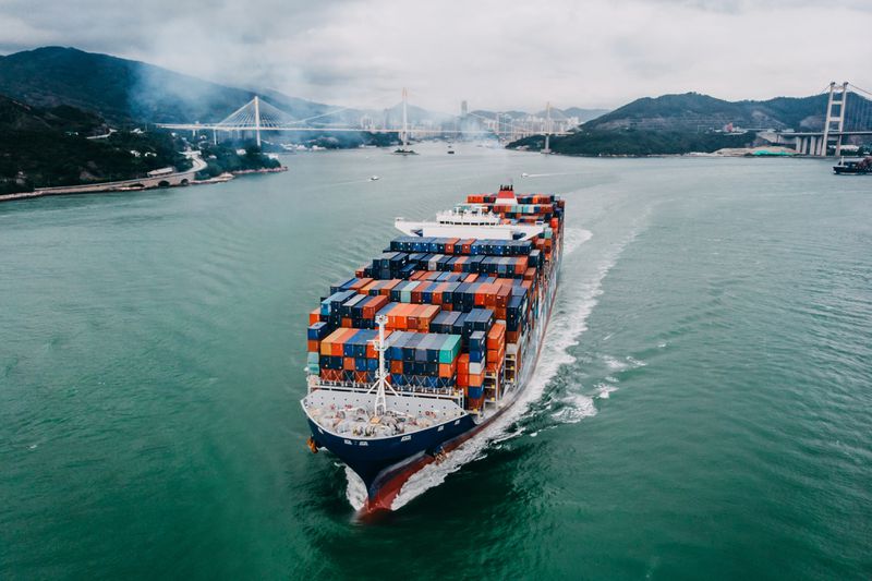 Fully loaded container ship sailing in the ocean
