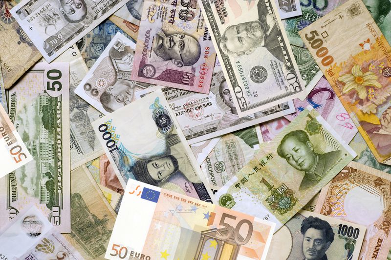 A pile of different currencies of the world